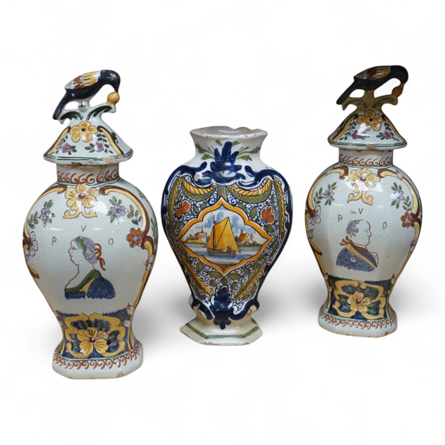 Three 18th/19th century Delft vases, the pair decorated with portraits of king and queen, H 30cm x W 15 (with lids), H 23cm x W 15 (without lid)